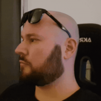 A Bald Man With A Beard Wearing Sunglasses And A Black Shirt With The Word Jka On It GIF