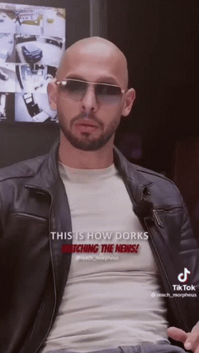 A Bald Man With A Beard Wearing Sunglasses And A Leather Jacket Says This Is How Dorks Watching The News GIF