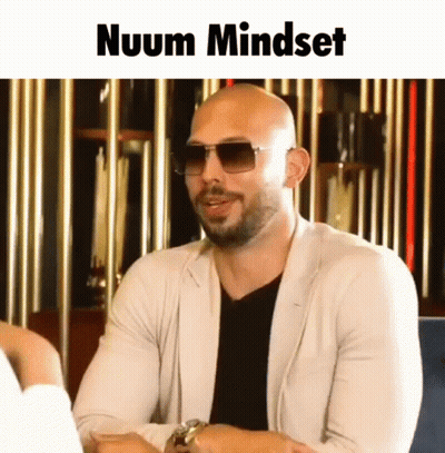 A Bald Man With A Beard Wearing Sunglasses And A White Jacket Says Nuum Mindset GIF