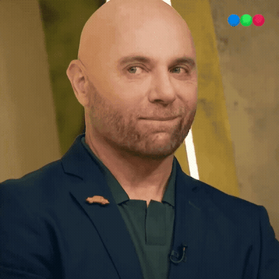 A Bald Man With A Beard Wears A Blue Suit GIF