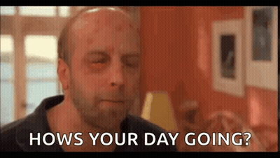 A Bald Man With A Black Eye Is Sitting In A Living Room And Asking Hows Your Day Going . GIF