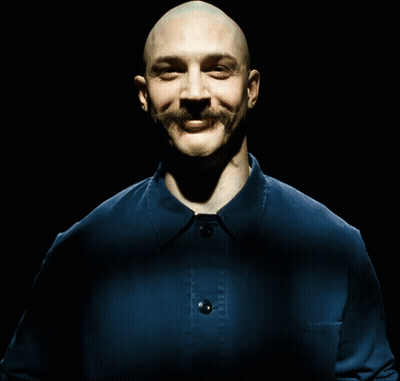 A Bald Man With A Mustache Is Laughing With His Mouth Open GIF