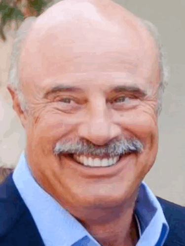 A Bald Man With A Mustache Is Smiling For The Camera . GIF
