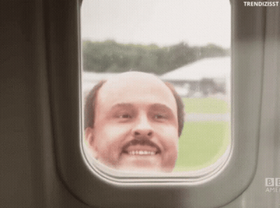 A Bald Man With A Mustache Looks Out A Window Of An Airplane GIF