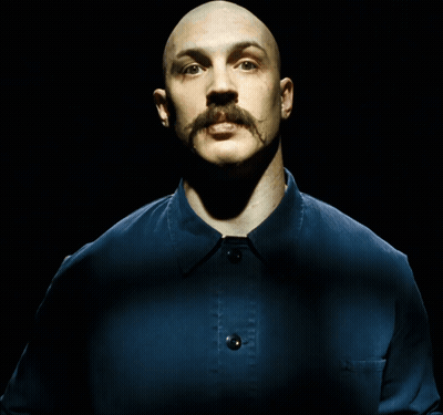 A Bald Man With A Mustache Wearing A Blue Shirt GIF