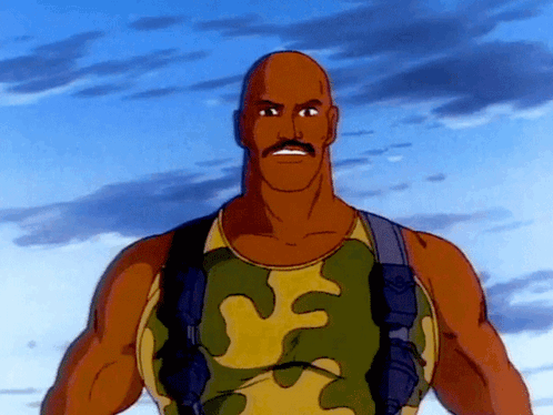 A Bald Man With A Mustache Wearing A Camouflage Tank Top GIF