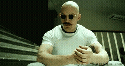 A Bald Man With A Mustache Wearing Sunglasses GIF