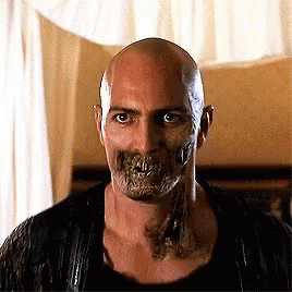A Bald Man With A Skull On His Face And Teeth . GIF