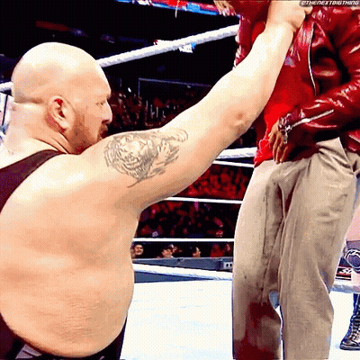 A Bald Man With A Tattoo On His Arm Holds Another Man 'S Arm GIF