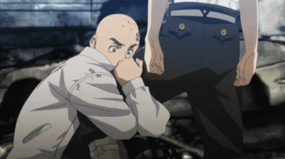 A Bald Man With A Tattoo On His Face Is Kneeling Down GIF