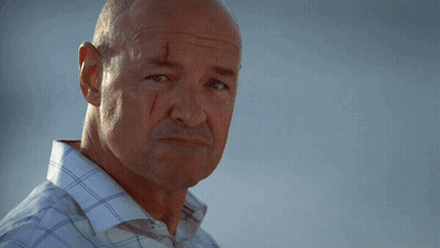 A Bald Man With Blood On His Face Is Smiling GIF
