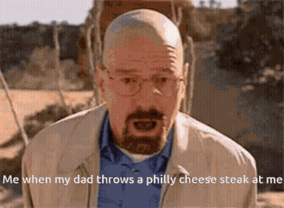 A Bald Man With Glasses And A Beard Is Talking About When His Dad Throws A Philly Cheese Steak At Him GIF