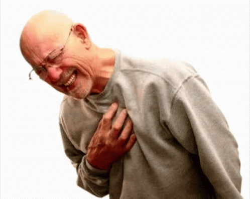 A Bald Man With Glasses Is Holding His Chest And Smiling GIF