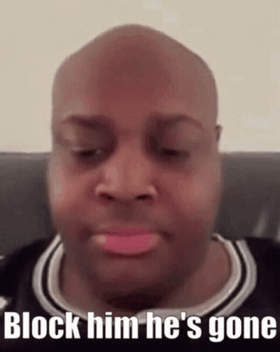 A Bald Man With Pink Lipstick On His Lips Is Sitting On A Couch And Says Block Him He 'S Gone . GIF