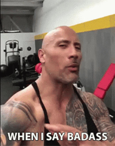 A Bald Man With Tattoos Is Talking In A Gym And Says " When I Say Badass " GIF