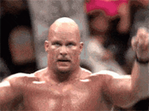 A Bald Man Without A Shirt Is Standing In Front Of A Crowd GIF