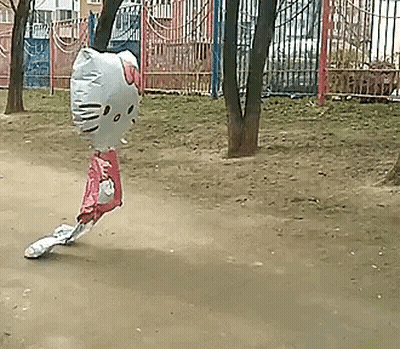 A Balloon In The Shape Of A Hello Kitty Is Flying Through The Air . GIF