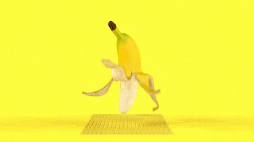 A Banana That Has Been Peeled On A Yellow Surface GIF