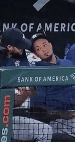 A Bank Of America Sign Is Behind A Baseball Dugout GIF