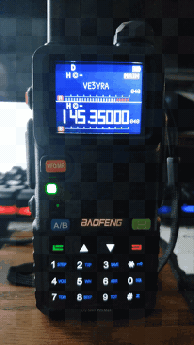 A Baofeng Radio Is Sitting On A Wooden Desk GIF