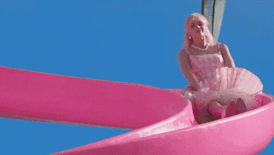 A Barbie Doll Is Going Down A Pink Water Slide In A Swimming Pool GIF