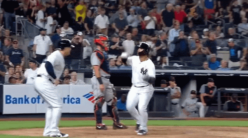 A Baseball Game Is Being Played In Front Of A Banner For Bank Of America GIF