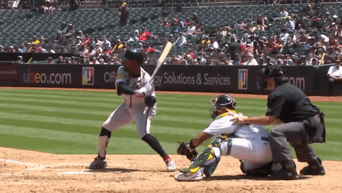 A Baseball Game Is Being Played In Front Of A Banner For Energy Solutions & Services GIF
