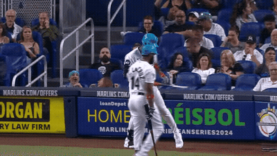 A Baseball Game Is Being Played In Front Of A Banner That Says Home GIF