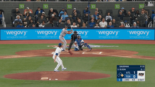 A Baseball Game Is Being Played In Front Of A Banner That Says " Wegovy " GIF