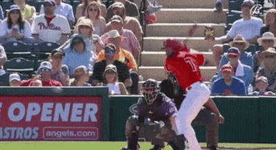 A Baseball Game Is Being Played In Front Of A Bottle Opener Sign GIF