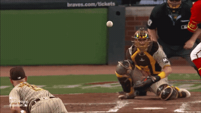 A Baseball Game Is Being Played In Front Of A Braves.com / Tickets Sign GIF