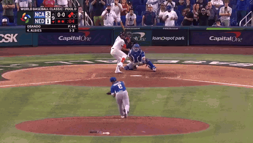 A Baseball Game Is Being Played In Front Of A Capital One Sign GIF