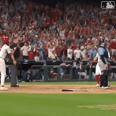 A Baseball Game Is Being Played In Front Of A Crowd With A Sign That Says Re/max On It GIF