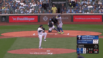 A Baseball Game Is Being Played In Front Of A Fred Meyer Ad GIF