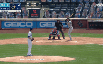 A Baseball Game Is Being Played In Front Of A Geico Ad GIF