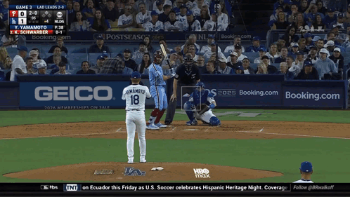 A Baseball Game Is Being Played In Front Of A Geico Sign GIF