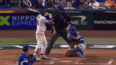 A Baseball Game Is Being Played In Front Of A Nippon Express Banner GIF