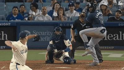 A Baseball Game Is Being Played In Front Of A Security Health Ad GIF