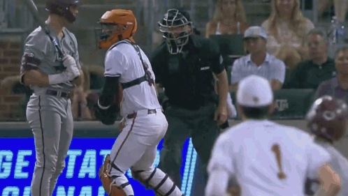 A Baseball Game Is Being Played In Front Of A Sign That Says Get Tat GIF