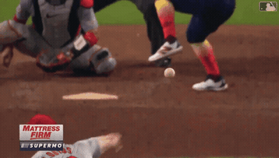 A Baseball Game Is Being Played In Front Of A Sign That Says " Mattress Firm " GIF