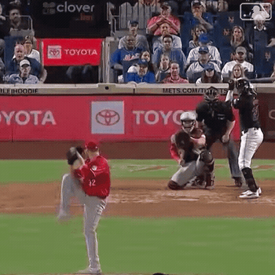 a baseball game is being played in front of a toyota banner
