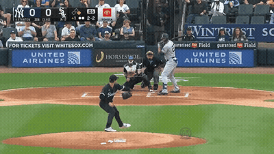 A Baseball Game Is Being Played In Front Of A United Airlines Sign GIF