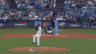 A Baseball Game Is Being Played In Front Of A Wall That Says Capital One On It GIF