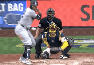 A Baseball Game Is Being Played In Front Of An Ad For It Bag GIF