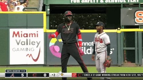 A Baseball Game Is Being Played In Front Of An Advertisement For Miami Valley Gaming GIF