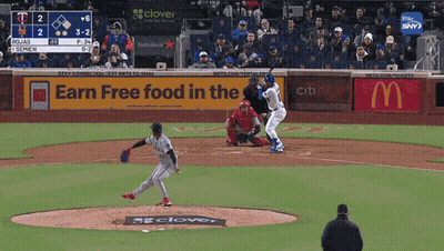 A Baseball Game Is Being Played In Front Of An Earn Free Food In The Mcdonald 'S Sign GIF