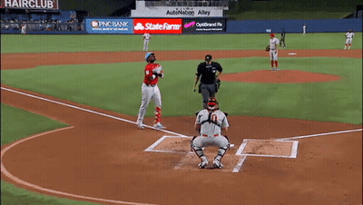 A Baseball Game Is Being Played On A Field That Has A Hair Club Sign GIF