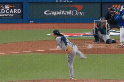 A Baseball Pitcher Is About To Throw A Ball In Front Of A Capital One Sign GIF