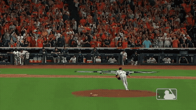 A Baseball Pitcher Is About To Throw The Ball In Front Of A Crowd That Is Cheering GIF