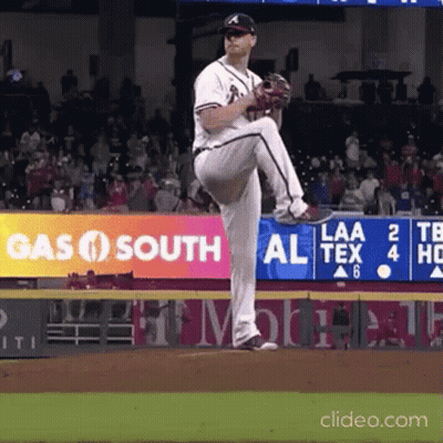 A Baseball Pitcher Is About To Throw The Ball In Front Of A Gas South Sign GIF